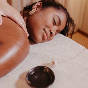 A woman enjoys a soothing massage at a spa, promoting relaxation and wellness.